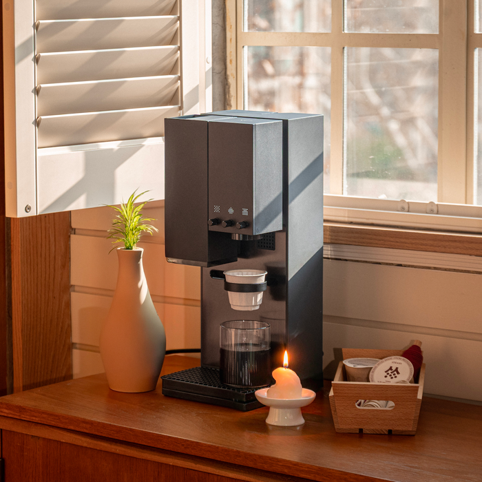 xBloom Studio in Midnight Black brewing on a wooden counter by a window